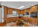 Spacious kitchen with wooden cabinets, a skylight, and an adjacent dining area for easy entertaining at 218 Countryside Rd, Kings Mountain, NC 28086