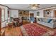 Comfortable living area with a stone fireplace, ceiling fan and a large area rug on hardwood floors at 218 Countryside Rd, Kings Mountain, NC 28086