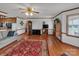 Cozy living room features hardwood floors, a decorative rug, and natural light streaming through large windows at 218 Countryside Rd, Kings Mountain, NC 28086