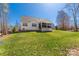 Large grassy backyard featuring a screened porch, perfect for outdoor entertaining and relaxation at 233 Catawba Crest Ln, Clover, SC 29710