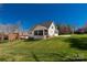 Large backyard with a screened porch, attached garage, and basketball court on a sunny day at 233 Catawba Crest Ln, Clover, SC 29710