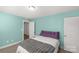 A cozy bedroom featuring soft lighting, a plush gray throw, and tranquil aqua walls at 233 Catawba Crest Ln, Clover, SC 29710