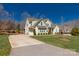 View of the home with a long driveway leading to an attached garage, surrounded by trees at 233 Catawba Crest Ln, Clover, SC 29710