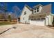Home exterior featuring a spacious driveway, two-car garage, basketball hoop, and well-maintained lawn at 233 Catawba Crest Ln, Clover, SC 29710