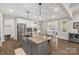 Modern kitchen with a large island, stainless steel appliances, and a view to dining area at 233 Catawba Crest Ln, Clover, SC 29710