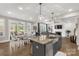 Open-concept space: kitchen island, dining area, and a view into a cozy living room at 233 Catawba Crest Ln, Clover, SC 29710