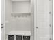 Practical mud room with storage bench, coat hooks and white cabinets at 233 Catawba Crest Ln, Clover, SC 29710