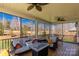 Relaxing screened porch with a cozy seating area and a view of the backyard and trees at 233 Catawba Crest Ln, Clover, SC 29710