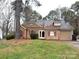 Charming single-story home featuring tan siding, red shutters, and an attached one car garage at 2517 Bushy Pine Ct, Charlotte, NC 28273