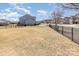 Spacious, fenced backyard with playground and lush lawn, perfect for outdoor activities at 3002 Paddington Dr, Indian Trail, NC 28079