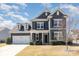 Charming two-story home with gray siding, white trim, and well-manicured landscaping at 3002 Paddington Dr, Indian Trail, NC 28079