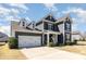 Charming two-story home with gray siding, white trim, and attached two car garage at 3002 Paddington Dr, Indian Trail, NC 28079