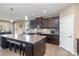 Modern kitchen with dark cabinets, granite countertops, and a large center island at 3002 Paddington Dr, Indian Trail, NC 28079