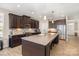 Modern kitchen with dark cabinets, granite countertops, and a large center island with seating at 3002 Paddington Dr, Indian Trail, NC 28079