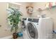 Laundry room with modern washer and dryer set and plant decoration at 3002 Paddington Dr, Indian Trail, NC 28079