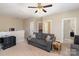 Carpeted loft features a sofa, ceiling fan, and adjacent bedrooms at 3002 Paddington Dr, Indian Trail, NC 28079