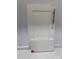 Close up of a white cabinet door with a silver handle and a 