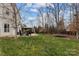 A spacious backyard showing the lush green lawn, patio area with furniture, and privacy provided by mature trees at 3549 Sandy E Trl, Fort Mill, SC 29707