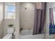 Well-lit bathroom features a shower-tub combo with neutral tile and a white toilet at 3549 Sandy E Trl, Fort Mill, SC 29707