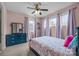 Charming bedroom featuring a blue frame bed, ceiling fan, and large windows with lilac curtains at 3549 Sandy E Trl, Fort Mill, SC 29707