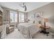 Comfortable bedroom with neutral tones, a ceiling fan, and abundant natural light from large windows at 3549 Sandy E Trl, Fort Mill, SC 29707
