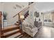 Elegant foyer showcasing wooden stairs, iron balusters, a stylish console table, and hardwood flooring at 3549 Sandy E Trl, Fort Mill, SC 29707