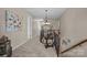 Upstairs hallway featuring carpet flooring and an ornate chandelier above wooden stairs and banisters at 3549 Sandy E Trl, Fort Mill, SC 29707