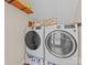 Laundry room featuring modern, front-loading washer and dryer and a rustic wooden shelf at 3549 Sandy E Trl, Fort Mill, SC 29707