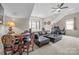 Spacious living room with a leather sectional, chess table, and comfortable seating arrangement at 3549 Sandy E Trl, Fort Mill, SC 29707