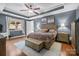 Main bedroom showcasing tray ceiling, neutral walls, and wood floors at 3549 Sandy E Trl, Fort Mill, SC 29707