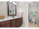 Well-maintained bathroom with a vanity, mirror, and a toilet visible through the doorway at 3815 10Th Ne St, Hickory, NC 28601