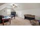 Large bonus room with a piano, television, and a comfortable seating area at 3815 10Th Ne St, Hickory, NC 28601