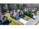 An aerial view of a two-story brick home with a long driveway and green lawn in a wooded neighborhood at 3815 10Th Ne St, Hickory, NC 28601