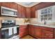 Well-lit kitchen offers stainless steel appliances, granite counters, and attractive wood cabinets at 3815 10Th Ne St, Hickory, NC 28601