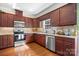 Well-equipped kitchen features stainless steel appliances, granite counters, and ample cherry wood cabinetry at 3815 10Th Ne St, Hickory, NC 28601