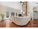 Cozy living room featuring a stone fireplace, hardwood floors, and bright windows at 3815 10Th Ne St, Hickory, NC 28601