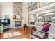 Open-concept living room with stone fireplace, hardwood floors, and a view of the staircase at 3815 10Th Ne St, Hickory, NC 28601