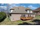 Exterior shot of a brick home featuring a wooden deck, roof shingles, and well-maintained landscaping, plus an air conditioning unit at 3815 10Th Ne St, Hickory, NC 28601