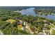 Scenic aerial view showcasing a charming home surrounded by dense trees near a tranquil lake and neighboring residences at 4808 1St Nw St, Hickory, NC 28601