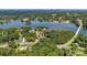 Expansive aerial view of a lakeside home nestled among lush greenery with lake views and a nearby marina at 4808 1St Nw St, Hickory, NC 28601