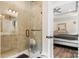 Luxurious bathroom with a frameless glass shower and a view into the bedroom at 4808 1St Nw St, Hickory, NC 28601