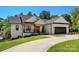 Inviting white brick home featuring a 2-car garage, covered porch, and well-maintained landscaping at 4808 1St Nw St, Hickory, NC 28601