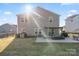 Spacious backyard with a patio area, perfect for outdoor entertaining, surrounded by lush greenery and a sunny sky at 5703 Eleanor Rigby Rd, Charlotte, NC 28278