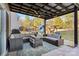 Inviting backyard patio with comfortable seating, an outdoor ceiling fan, and a view of the playground at 5703 Eleanor Rigby Rd, Charlotte, NC 28278