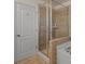 Elegant bathroom featuring a glass-enclosed shower with decorative tile, alongside a luxurious soaking tub at 5703 Eleanor Rigby Rd, Charlotte, NC 28278