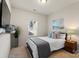 Cozy bedroom with a queen bed, neutral decor, and a large window at 5703 Eleanor Rigby Rd, Charlotte, NC 28278