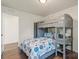 A cozy bedroom featuring a gray bunk bed with stylish bedding and a built-in desk and shelving unit at 5703 Eleanor Rigby Rd, Charlotte, NC 28278