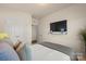 Comfortable bedroom featuring a large window, TV, a queen bed, and an ensuite bathroom at 5703 Eleanor Rigby Rd, Charlotte, NC 28278