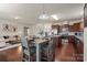 Open dining area and kitchen combination with stainless steel appliances and granite countertops at 5703 Eleanor Rigby Rd, Charlotte, NC 28278