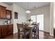 Inviting dining area with hardwood floors, a modern light fixture and a sliding door to the outside at 5703 Eleanor Rigby Rd, Charlotte, NC 28278